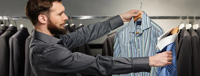 man choosing striped shirt