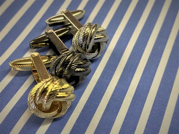 x1 pair of silver coloured knot cufflinks with box