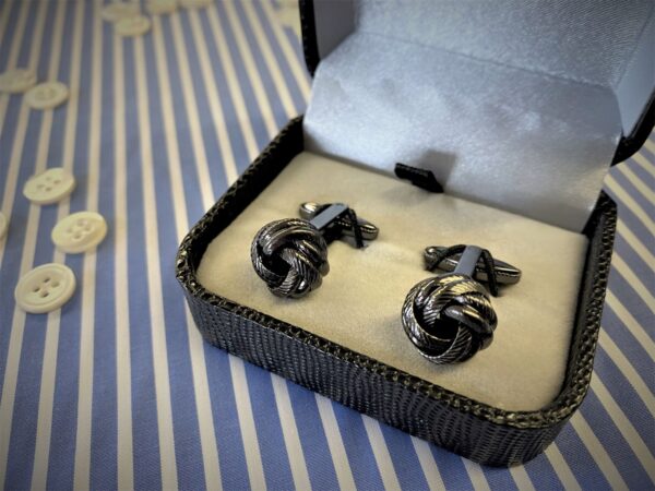 x1 pair of black coloured knot cufflinks with box