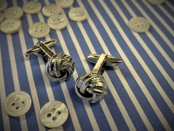 x1 pair of silver coloured knot cufflinks with box